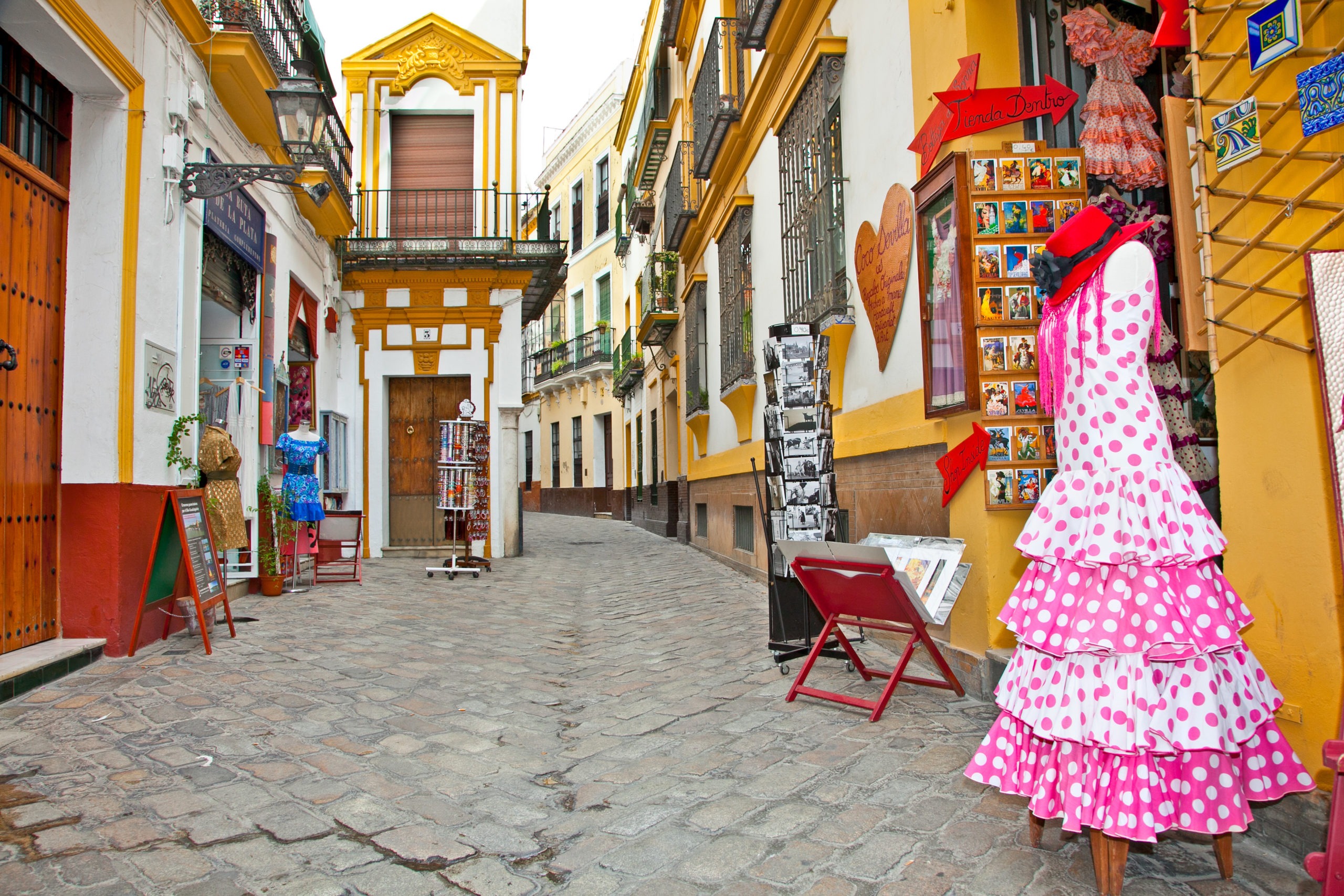 SEVILLE, SPAIN - SEP 11: Shopping street with typical flamenco dress on Sep 11, 2011 in Seville, Spain. The most typical Spanish flamenco dress features a polka dotted pattern is Traje de Lunares.